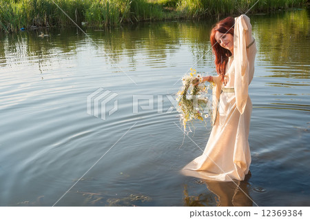 Beautiful red-haired girl relaxes in water Beautiful red-haired girl relaxes in water 12369384