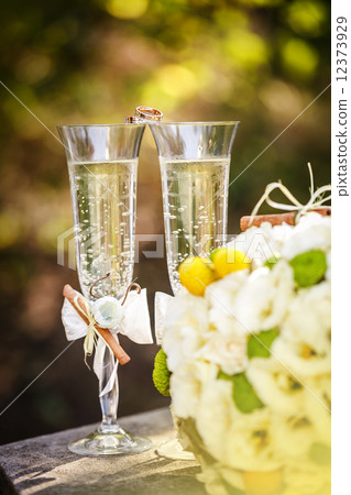 Wedding rings with roses and glasses of champagne 12373929