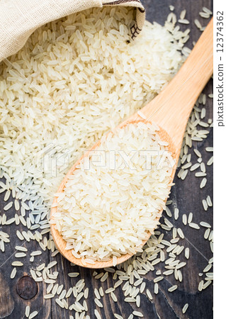 White uncooked rice in a spoon White uncooked rice in a spoon 12374362