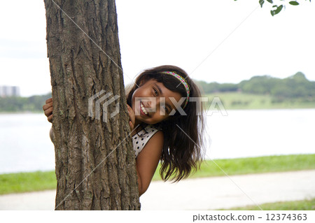 Young Indian Girl playing in park Young Indian Girl playing in park 12374363