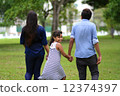 Young Indian family strolling in park 12374397