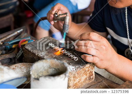 jeweler's hands while working making jewelry in Vientiane, Laos jeweler's hands while working making jewelry in Vientiane, Laos 12375396