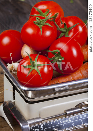 Fresh red tomatoes on a kitchen scale 12375469