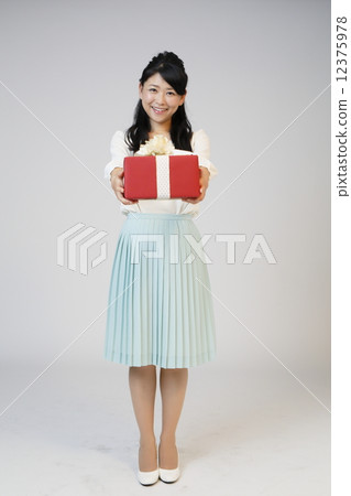 A young woman giving a gift 12375978
