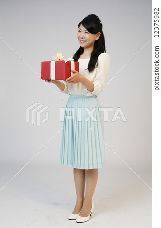 A young woman giving a gift 12375982
