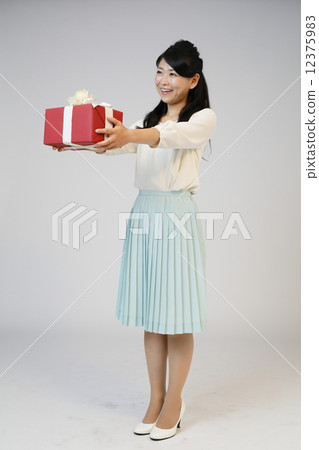 A young woman giving a gift 12375983