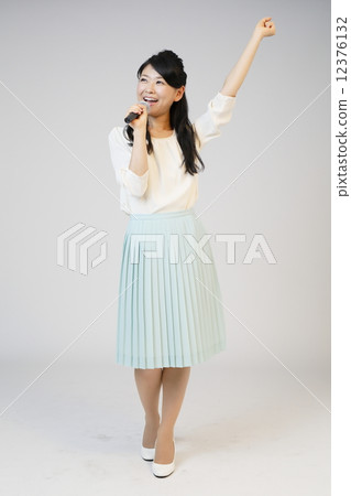 A young lady singing karaoke A young lady singing karaoke 12376132