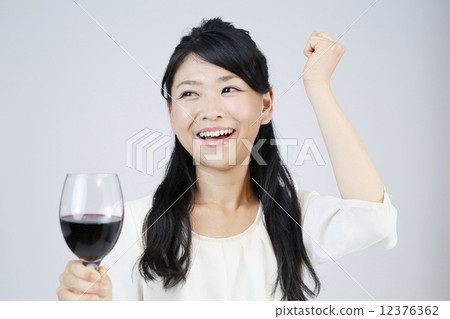 A young woman drinking wine A young woman drinking wine 12376362