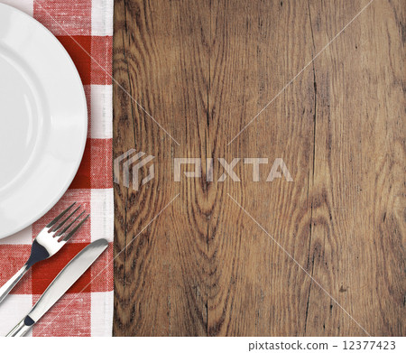 dinner table with setting plate and cutlery top view dinner table with setting plate and cutlery top view 12377423