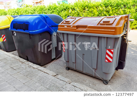 Variety dumpsters(recycling containers ) on a city street. 12377497