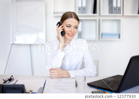 young business woman talking on cell phone young business woman talking on cell phone 12377910