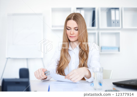 Portrait of a beautiful young smiling business woman doing some Portrait of a beautiful young smiling business woman doing some 12377914