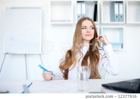 Portrait of a beautiful young business woman working in bright o Portrait of a beautiful young business woman working in bright o 12377916