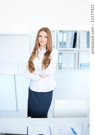 Portrait of happy young business woman standing with hands folde Portrait of happy young business woman standing with hands folde 12377921