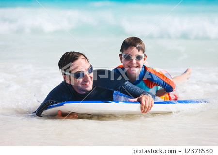 Father and son surfing 12378530