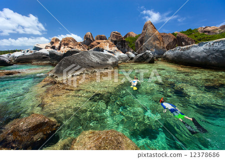 Family snorkeling at tropical water Family snorkeling at tropical water 12378686
