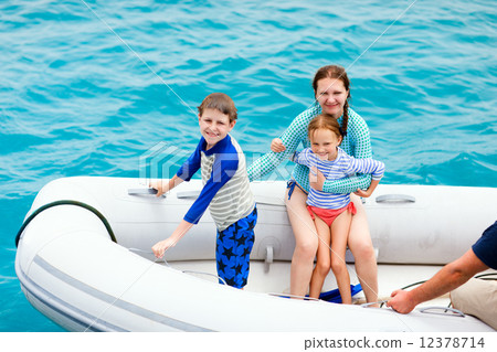 Family in inflatable dinghy boat 12378714