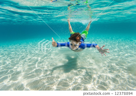 Boy swimming underwater Boy swimming underwater 12378894