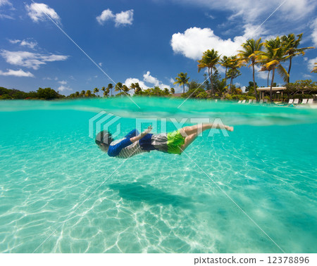 Little boy swimming in ocean Little boy swimming in ocean 12378896