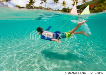 Little boy swimming in ocean Little boy swimming in ocean 12378897