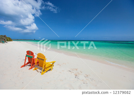Colorful adirondack lounge chairs at Caribbean beach 12379082