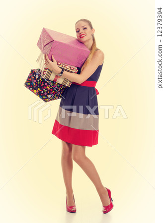 Pretty girl holding a gift box. PinUp style. Pretty girl holding a gift box. PinUp style. 12379394