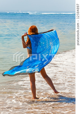 The young beautiful woman on an ocean coast. The young beautiful woman on an ocean coast. 12384897