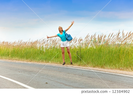 Hitchhiking girl votes on road Hitchhiking girl votes on road 12384902