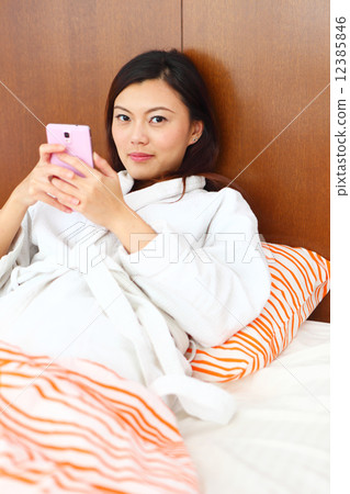 Young Women, Home, Resort, Hotel, apartment, Condo, Lifestyle, playful, siting, bed, mobile, blanket Young Women, Home, Resort, Hotel, apartment, Condo, Lifestyle, playful, siting, bed, mobile, blanket 12385846