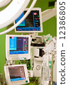 anaesthesiolog monitors in operation surgery room with green lights on 12386805