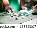 Doctor taking surgery tools from the table in Israel 12386807
