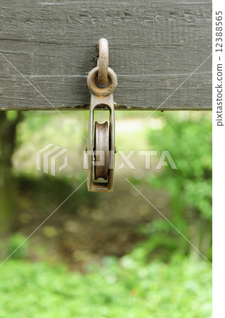 rusty pulley attached on the wood 12388565