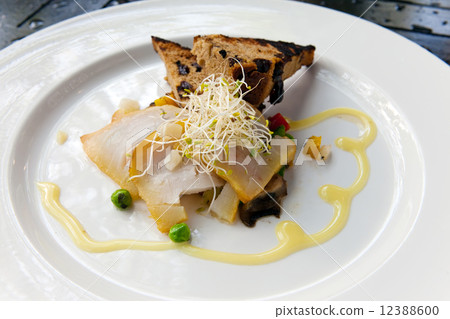 Slices smoked marlin and roasted bread on plate 12388600