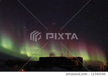 Wooden building and pink aurora 12389298