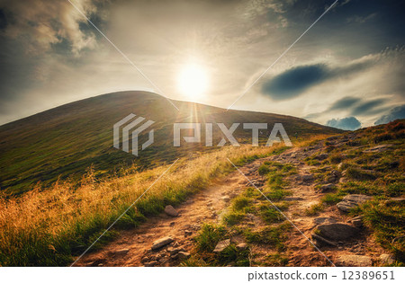 mountain landscape view of Goverla in sunlight and dirt road 12389651