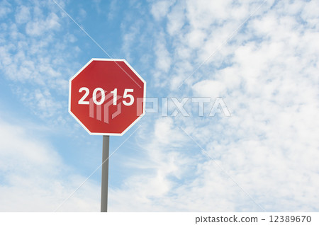 red road sign with a text of 2015 under blue sky 12389670
