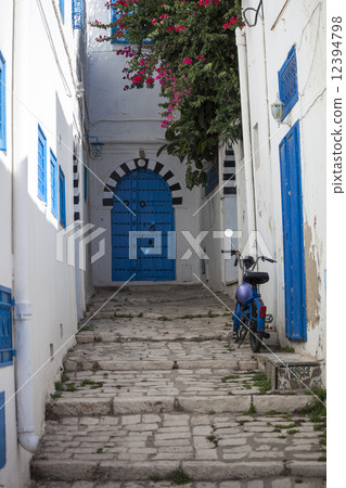 Narrow street with moped in Sidi Bou Said, Tunisia 12394798