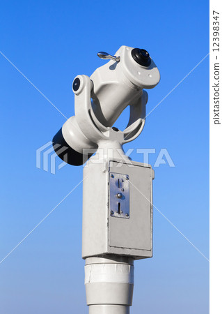 White paid tourist telescope on blue sky background 12398347