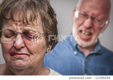 Battered and Scared Woman with Ominous Man Behind 12399268