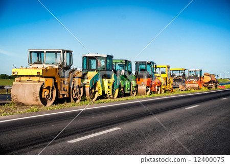 Heavy Vibration roller at asphalt pavement works. Concept photo of road works. Heavy Vibration roller at asphalt pavement works. Concept photo of road works. 12400075