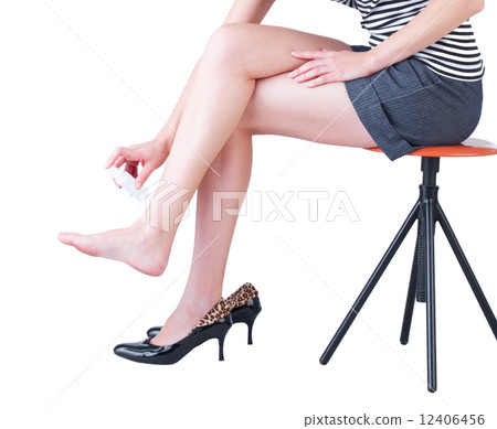A woman using a foot deodorant spray A woman using a foot deodorant spray 12406456