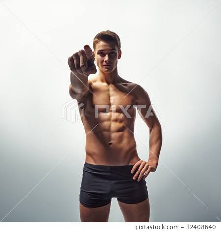 Muscular man in underwear pointing forward Muscular man in underwear pointing forward 12408640