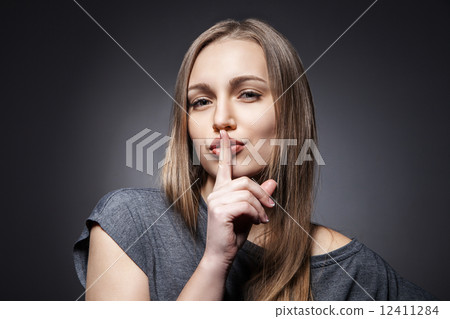 Young Woman Gesturing for Quiet or Shushing 12411284