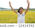 A girl waving a hand 12414392