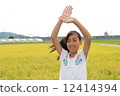A girl waving a hand 12414394