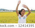 A girl waving a hand 12414395