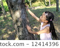 A girl climbing a tree 12414396