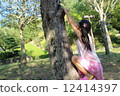 A girl climbing a tree 12414397