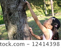 A girl climbing a tree 12414398