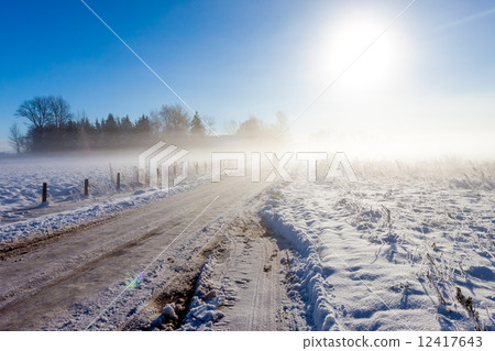 Mother and child on foggy snow road Mother and child on foggy snow road 12417643